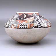 A polychrome jar decorated with a four-panel phases of the moon and geometric design above the shoulder, click or tap to see a larger version
