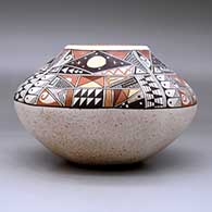 A polychrome jar decorated with a four-panel phases of the moon and geometric design above the shoulder, click or tap to see a larger version
