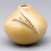 A miniature buff seed pot with an organic opening and decorated with an ear of corn applique
 by Iris Nampeyo of Hopi