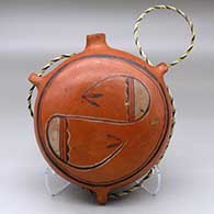 Click for a larger view A polychrome canteen with three loop handles and decorated on top with a geometric design
by Nampeyo of Hano of Hopi