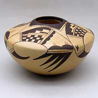 A black on yellow seed pot decorated with a four panel bird hanging from sky band and geometric design
 by Ramon Howato of Hopi