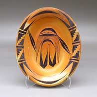An oval polychrome serving bowl decorated inside and around the rim with a bird element and geometric design
 by Nampeyo of Hano of Hopi