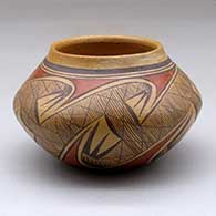 A small polychrome bowl decorated around the body with a migration pattern design
 by Dextra of Hopi