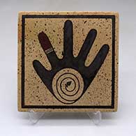 A polychrome tile decorated with a hand, spiral and geometric design
 by Stetson Setalla of Hopi