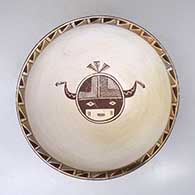 A polychrome bowl decorated on the inside with a black on white katsina design and on the outside with a four panel geometric design and fire clouds
 by Nathan Begaye of Hopi