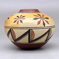 A polychrome jar decorated with a flower and geometric design, click or tap to see a larger version