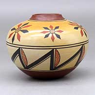 A polychrome jar decorated with a flower and geometric design, click or tap to see a larger version