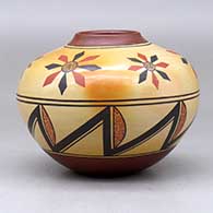 A polychrome jar decorated with a flower and geometric design, click or tap to see a larger version