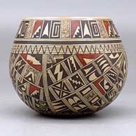 A polychrome bowl polished on the inside and decorated around the outside with a four panel small sherd and geometric design, click or tap to see a larger version