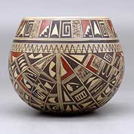A polychrome bowl polished on the inside and decorated around the outside with a four panel small sherd and geometric design, click or tap to see a larger version