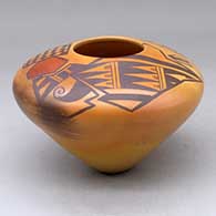 A polychrome jar decorated above the high shoulder with a bird element, crosshatch, checkerboard and geometric design, plus fire clouds
 by Garrett Maho of Hopi
