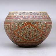 A polychrome bowl polished on the inside and decorated around the outside with a four panel small shard, fineline and geometric design, click or tap to see a larger version
