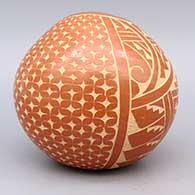 Red bowl with organic opening and sgraffito geometric design, click or tap to see a larger version