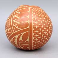 Red bowl with organic opening and sgraffito geometric design, click or tap to see a larger version