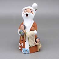 Polychrome Santa Claus storyteller with three children, list, candy cane, and wrapped presents
 by Diane Lucero of Jemez