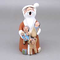 Polychrome Santa Claus storyteller with three children and wrapped presents
 by Diane Lucero of Jemez