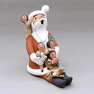 A sitting Santa Claus storyteller figure with four children and a kitten
 by Diane Lucero of Jemez