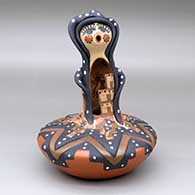 A polychrome Singing Angel figure atop a painted and carved jar
 by Felicia Fragua of Jemez