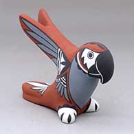 A parrot with upraised wings and decorated with bird element and geometric design
 by Darrick Tsosie of Jemez
