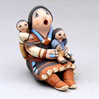 A miniature sitting grandmother storyteller with two children
 by Mary Lucero of Jemez