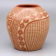 A red jar decorated with a two-panel sgraffito scroll, snowflake, kiva step and geometric design
 by Wilma Baca Tosa of Jemez