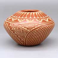 A red jar decorated with a two-panel sgraffito feather, snowflake, kiva step and geometric design
 by Wilma Baca Tosa of Jemez