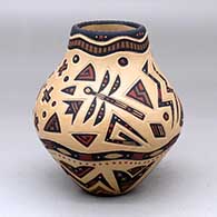 A polychrome jar decorated with a lightly-carved and painted four-panel dragonfly and geometric design
 by Glendora Fragua of Jemez