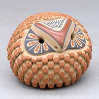 A small polychrome owl figure with a feather and geometric design
 by Laura Gachupin of Jemez