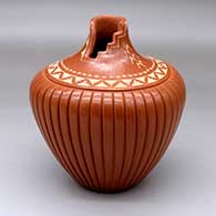 A red melon jar with a kiva step cut opening, sgraffito corn plants and geometric design above the shoulder and with a carved melon body
 by Alvina Yepa of Jemez