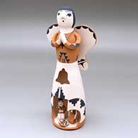 A standing polychrome Singing Angel with a nativity scene inside a cutout in her skirt
 by Angel Bailon of Jemez