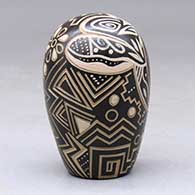 A brown and tan seed pot with a sgraffito and painted geometric design, click or tap to see a larger version