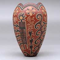 A polychrome vase with a scalloped rim and decorated with a lightly-carved and painted four-panel kachina, flower and geometric design, click or tap to see a larger version