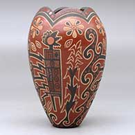 A polychrome vase with a scalloped rim and decorated with a lightly-carved and painted four-panel kachina, flower and geometric design, click or tap to see a larger version