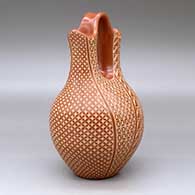 A red wedding vase decorated with a sgraffito snowflake, scroll and geometric design, click or tap to see a larger version
