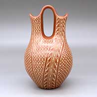 A red wedding vase decorated with a sgraffito snowflake, scroll and geometric design, click or tap to see a larger version