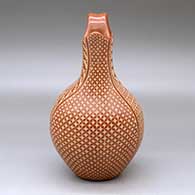 A red wedding vase decorated with a sgraffito snowflake, scroll and geometric design, click or tap to see a larger version