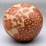 A red seed pot decorated with a sgraffito hummingbird, flower, vine and geometric design, click or tap to see a larger version