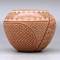 A red jar decorated with a sgraffito snowflake, scroll, kiva step and geometric design, click or tap to see a larger version
