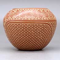 A red jar decorated with a sgraffito snowflake, scroll, kiva step and geometric design, click or tap to see a larger version