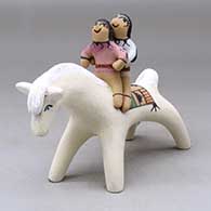 A polychrome horse figure with two children on its back
 by Clifford Kim Fragua of Jemez