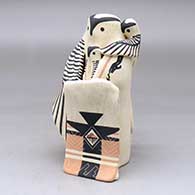 A standing polychrome owl dancer in full dress, with two of his children
 by Loren Wallowing Bull of Jemez
