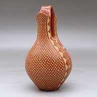 A red wedding vase decorated with a sgraffito four-panel snowflake and geometric design, click or tap to see a larger version