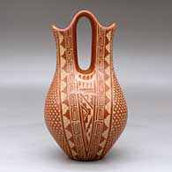 A red wedding vase decorated with a sgraffito four-panel snowflake and geometric design, click or tap to see a larger version