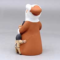 A standing Santa Claus storyteller figure with four children and gifts, click or tap to see a larger version