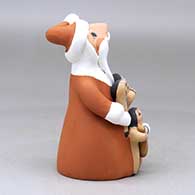 A standing Santa Claus storyteller figure with four children and gifts, click or tap to see a larger version