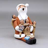 A sitting Santa Claus storyteller figure with five children and gifts, click or tap to see a larger version