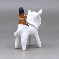 A polychrome figure with a little girl holding her younger sister and her drum on the back of a sacred white bison, click or tap to see a larger version