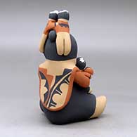 A sitting grandmother storyteller figure with four children on her, click or tap to see a larger version