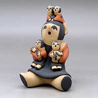 A sitting grandmother storyteller figure with four children on her, click or tap to see a larger version