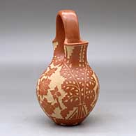 A red wedding vase decorated with a sgraffito hummingbird, butterfly, flower, leaf, branch and geometric design, click or tap to see a larger version